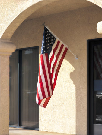 US flag mounted outside a place of businessの写真素材