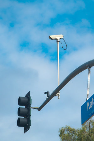 Surveillance camera mounted on a traffic light poleの写真素材