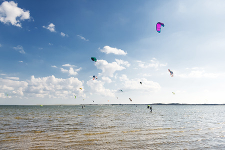 Kiteboarding competition, many kites in the skyの写真素材