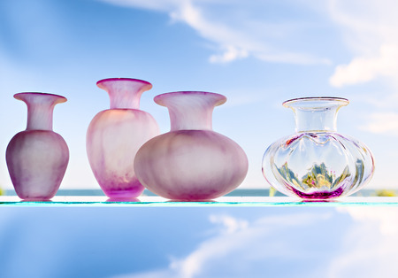 Four glass vases on the abstract backgroundの写真素材