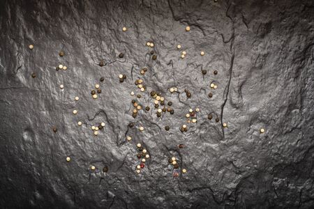 Pepper grainy, spilled on the surface of a stone slab.の写真素材