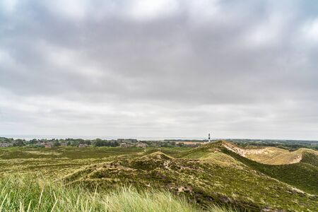 Lighthouse black white on dune vertical. Focus on background with lighthouse.の写真素材
