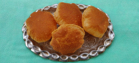 Indian traditional food puri or poori fried roti in blur bokeh backgroundの写真素材