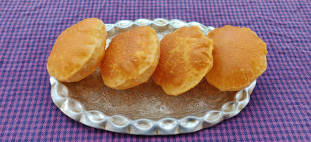 Indian traditional food puri or poori fried roti in blur bokeh background