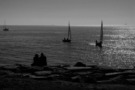 young lovers watching the sea.の写真素材