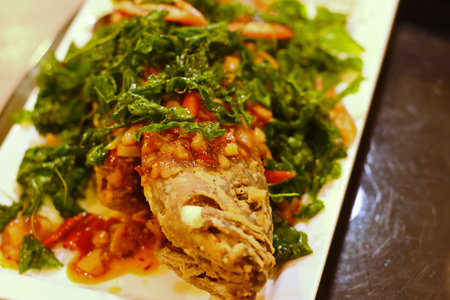 Fried grouper topped with sweet, sour and hot sauceの写真素材