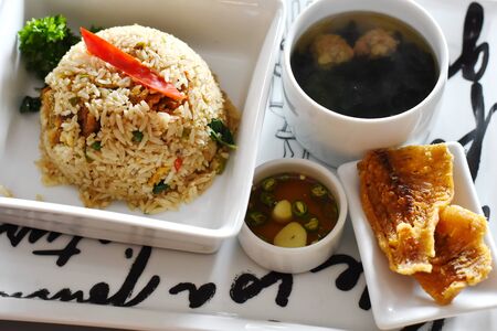 fried rice with crispy fishの写真素材