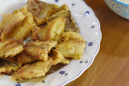Crispy fried pork skin on a white plate, Thailand.の写真素材