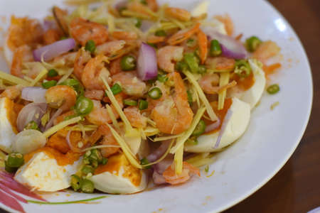 Thai spicy salad with shrimp and egg on white plate, Thai foodの写真素材