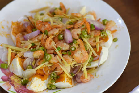 Thai spicy salad with shrimp and egg on white dish, Thai foodの写真素材