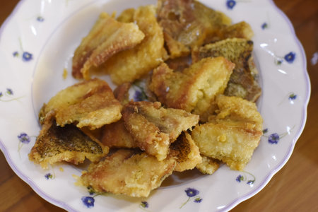 Fried fish fillets on a white plate, close-upの写真素材