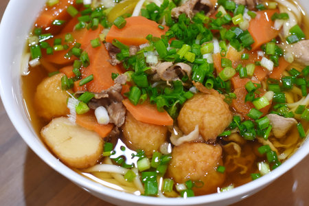 Vietnamese soup with meatballs and vegetables in a bowl.