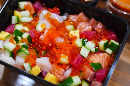 Salmon sashimi with cucumber, red caviar and mango