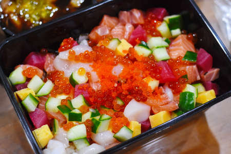 Sashimi with salmon and cucumber in plastic boxの写真素材