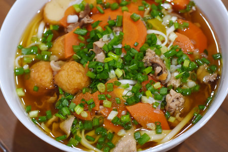 Vietnamese noodle soup with pork and vegetables in a bowl