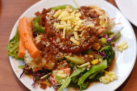 salad with beef and vegetables on white plate in the restaurant.
