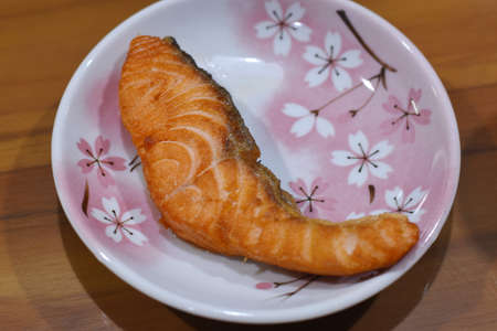 Salmon steak on a plate with cherry blossom. Japanese foodの写真素材