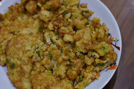Crispy fried cauliflower with green onions on white plate.の写真素材