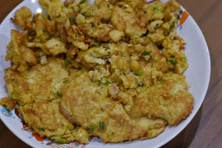 Thai style fried egg omelet with green onion on plateの写真素材