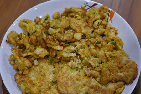 Thai food, fried fish cake in white dish on wooden tableの写真素材