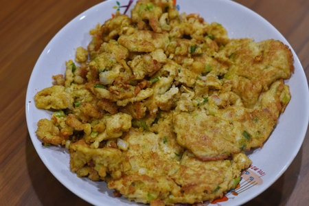 Thai style fried fish cake with egg on the white plate.