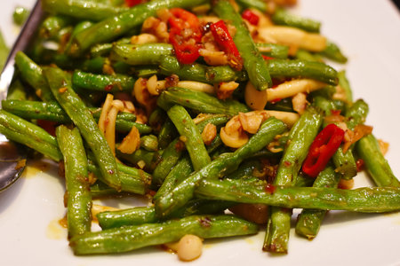 stir-fried green beans with chilli on the white plateの写真素材