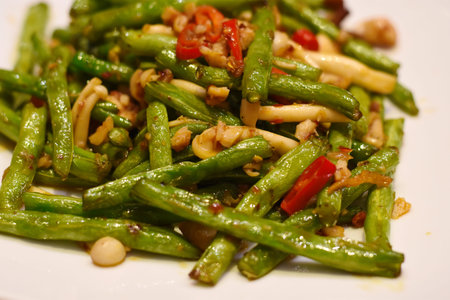 Stir fried green beans on white plate.