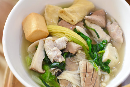 Vietnamese noodle soup with pork and vegetable in a bowl