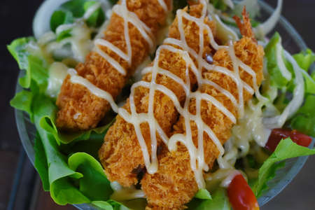 Crispy fried shrimp with mayonnaise and lettuce salad.の写真素材