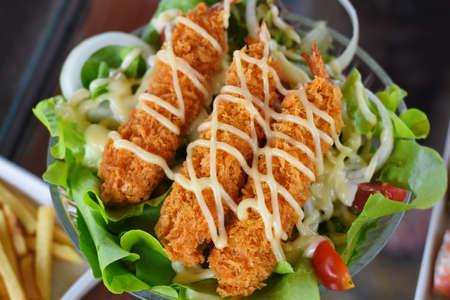 Close up of deep fried chicken nuggets with saladの写真素材