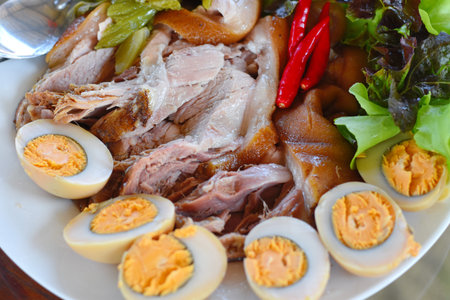 boiled egg with pork in white dish on wood table,Thai food