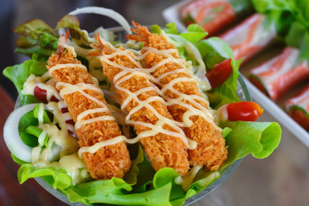 Salad with fried shrimp, lettuce, tomato and mayonnaiseの写真素材