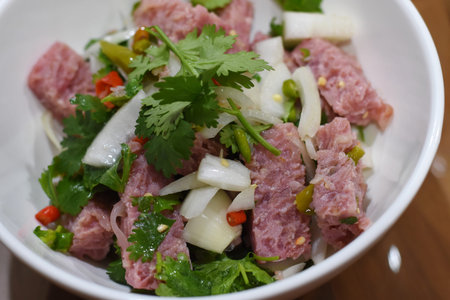 Thai spicy salad with pork, cucumber, onion and cilantro