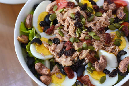 Tuna salad with pumpkin seeds, raisins and sunflower seedsの写真素材