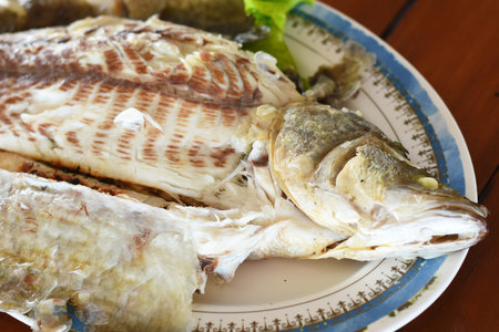 Fried fish with salt and pepper on the plate, stock photo
