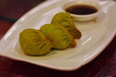 Fried Dumplings with dipping sauce in a restaurant in Thailand.の写真素材