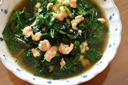 stir-fried kale with shrimps and garlic in bowlの写真素材