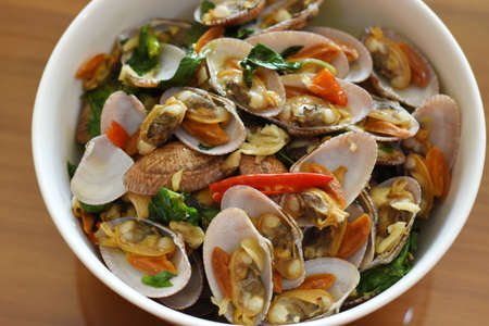 Stir-fried clams with chili and garlic in a bowlの写真素材