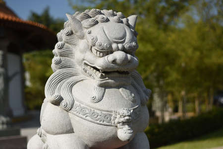Stone lion statue in the park, close-up, selective focus.の写真素材