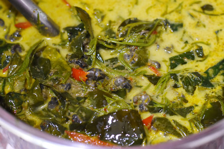Spinach in a bowl with spoon.