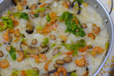 rice porridge with mushrooms and shrimps in a saucepan