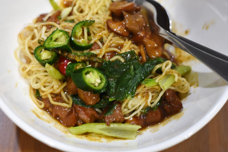 Stir-fried noodle with pork and vegetable in Thailand.