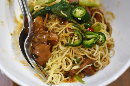 Fried noodle with pork and vegetable in the white bowl.の写真素材