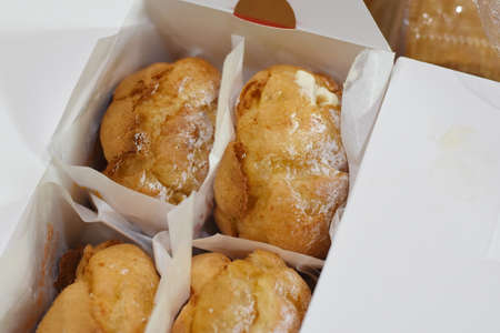 Eclairs in a paper box on a white background. Close-upの写真素材