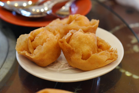 Deep-fried dumplings on a plate in a restaurant.