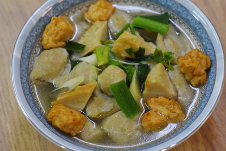 Fried tofu with egg and vegetable in a bowl on the table