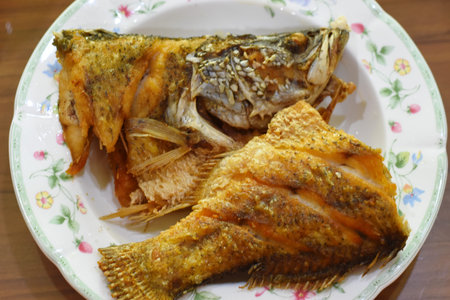 Fried fish with salt and pepper on plate, Thai food.