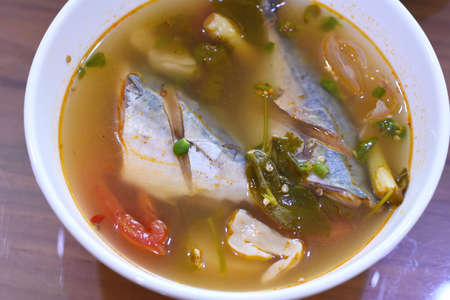 Soup with mackerel fish in a bowl on the tableの写真素材