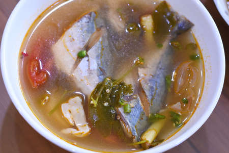 Saba fish soup in a bowl on wooden table, top viewの写真素材
