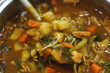 stir-fried vegetables with curry in a pot, close up